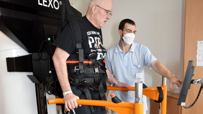 Patient auf Gangtrainer in Begleitung eines Physiotherapeuten - Interdisziplinäres Therapiezentrum - Neurologie - Albertinen Krankenhaus Hamburg Patient auf Gangtrainer in Begleitung eines Physiotherapeuten - Interdisziplinäres Therapiezentrum - Neurologie - Albertinen Krankenhaus Hamburg